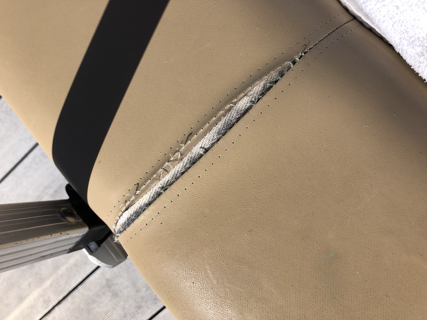 Bench seat with a split seam before the repair