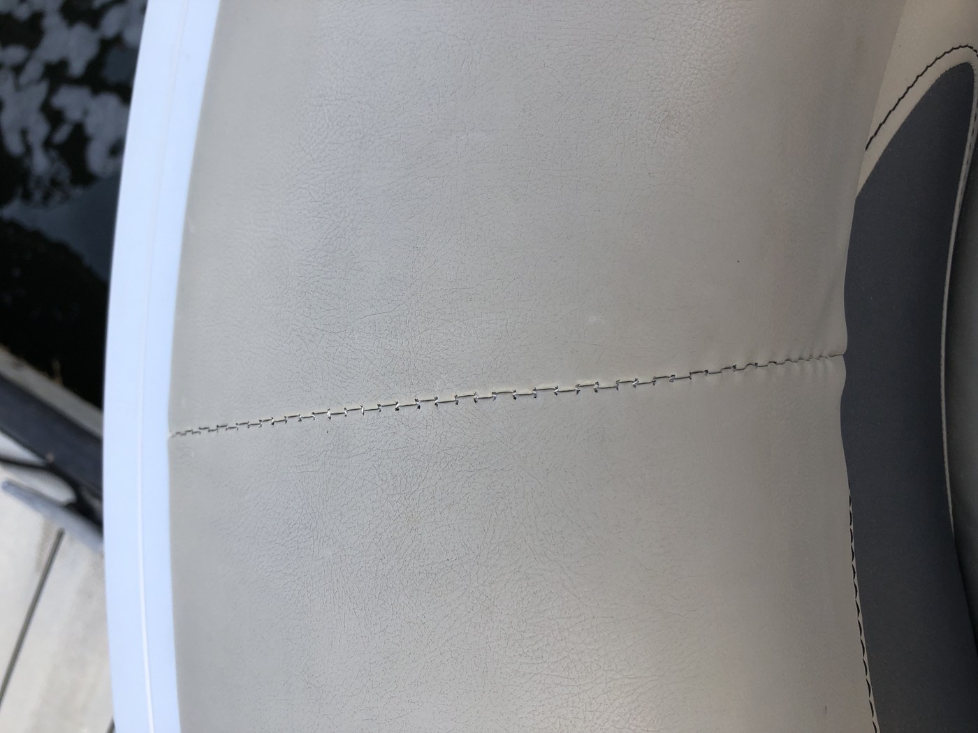 Close-up of a finished seam on white upholstery